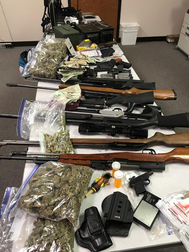 Dustin King Road, another table with weapons, money, and drugs